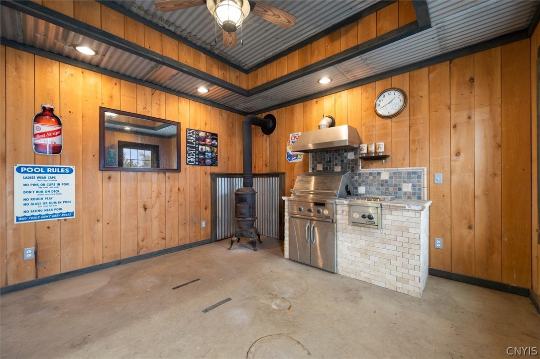 1322 Sawmill Road Sangerfield, NY 13480 - Photo 48 of 50 Rustic wood paneled walls complement the concrete flooring and built-in cooking station.