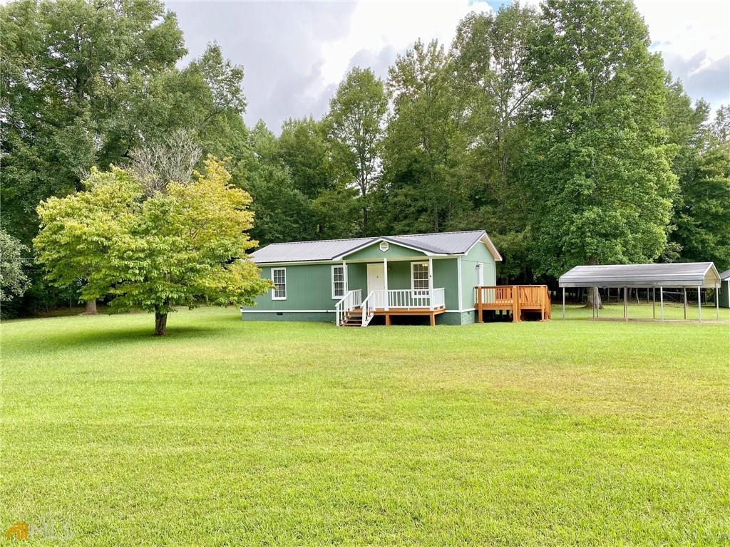 4205 Stateline Road Bowdon, GA 30108 - Photo 1 of 1 a front view of a house with a garden