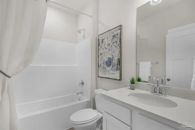 a bathroom with a granite countertop sink a toilet and bathtub