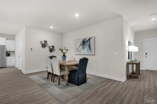a view of a dining room with furniture and wooden floor