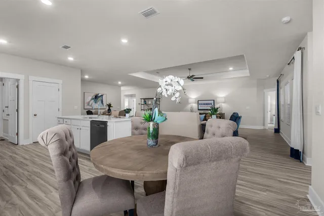 a living room with furniture and a dining table with kitchen view