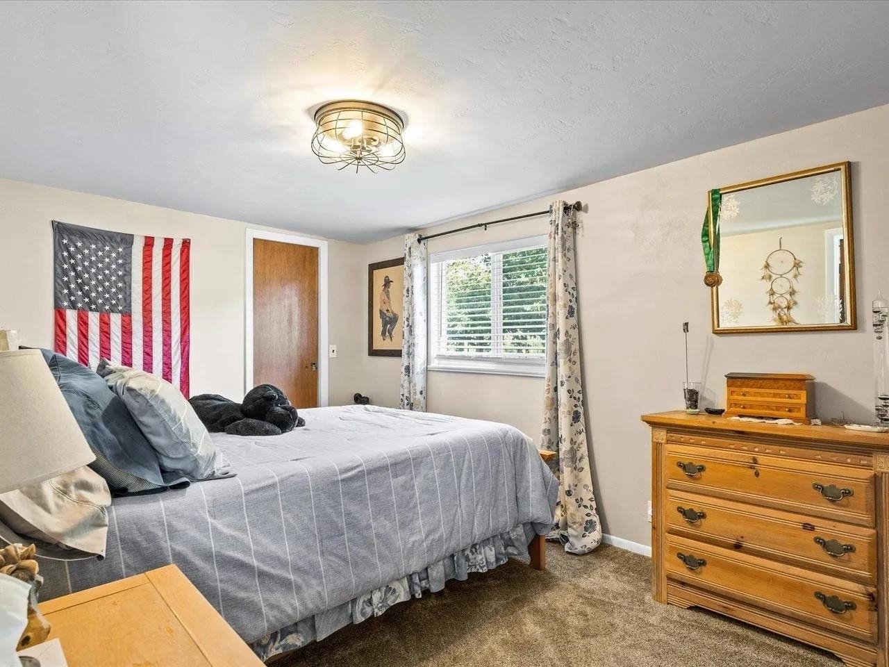 3669 G Road Palisade, CO 81526 - Photo 13 of 40 a bedroom with a bed and a chandelier