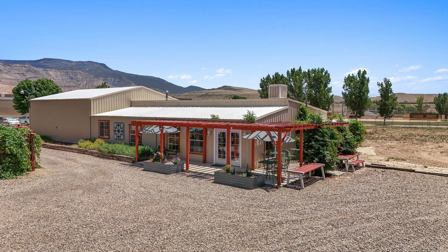 3669 G Road Palisade, CO 81526 - Photo 22 of 40 an outdoor space with patio and white umbrellas