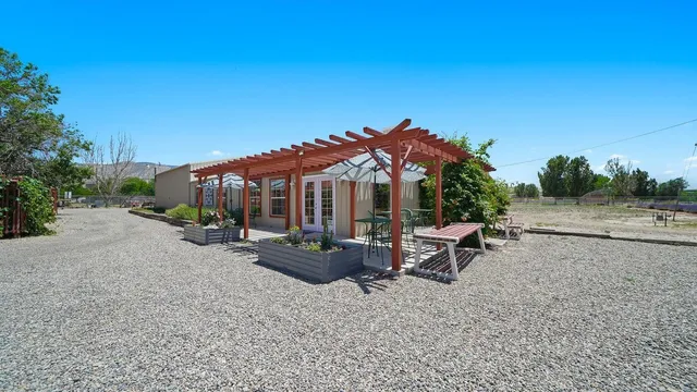 a view of a house with backyard and sitting area