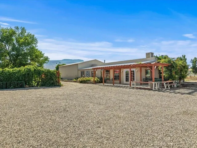a front view of house with yard and trees in the background