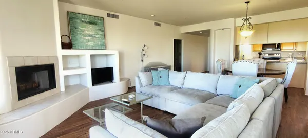 a living room with furniture a fireplace and a flat screen tv