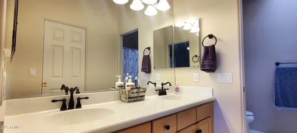 a bathroom with double vanity sinks and a mirror
