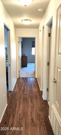 a view of a hallway view with wooden floor and staircase