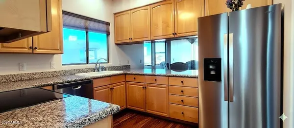 a kitchen with stainless steel appliances granite countertop a refrigerator sink and cabinets