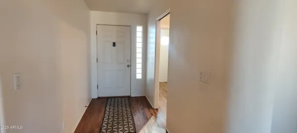 a view of bedroom with wooden floor