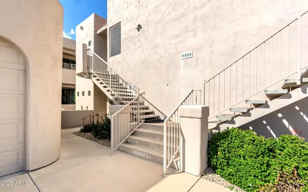 a view of a balcony with wooden floor and fence