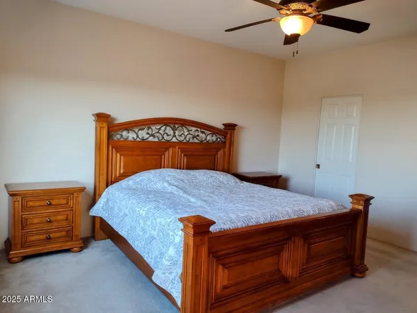 a bed sitting in a bedroom chandelier