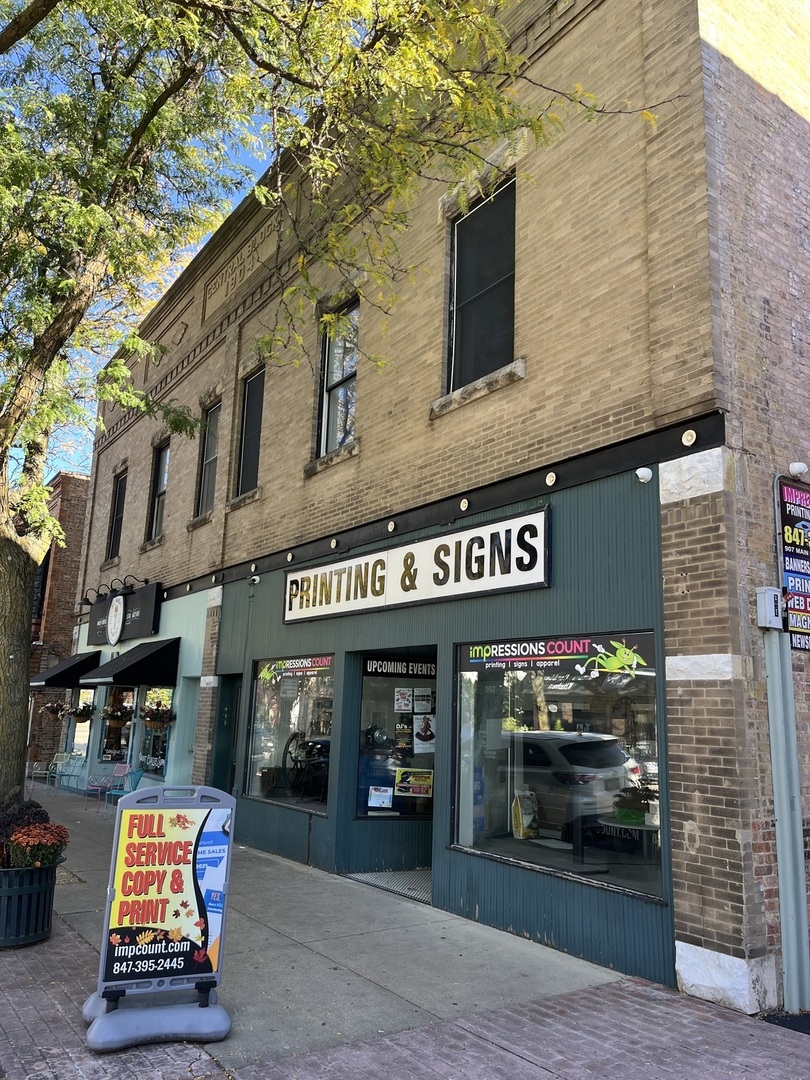 a front view of building with retail shop and retail shops