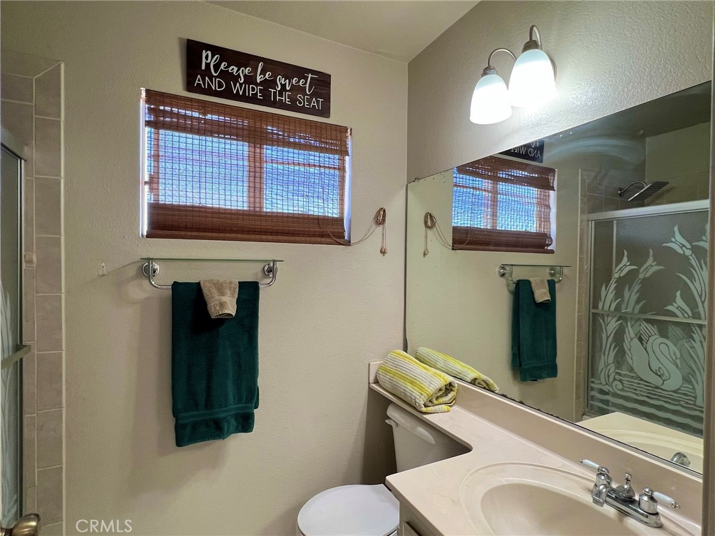 1505 Salmon River Road Riverside, CA 92501 - Photo 14 of 20 a bathroom with a toilet sink and mirror