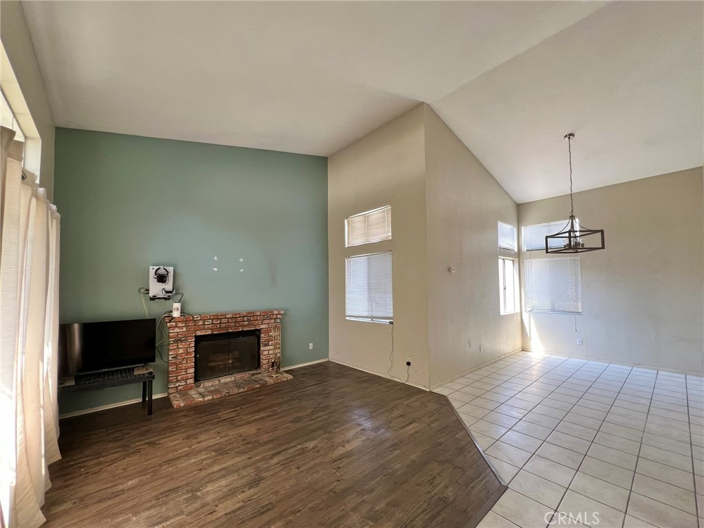 1505 Salmon River Road Riverside, CA 92501 - Photo 2 of 20 a view of empty room with wooden floor and fireplace