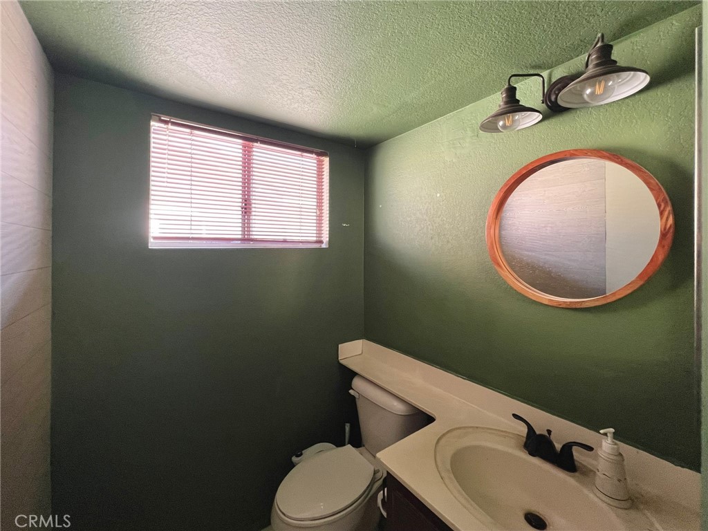1505 Salmon River Road Riverside, CA 92501 - Photo 10 of 20 a bathroom with a toilet mirror vanity and a sink