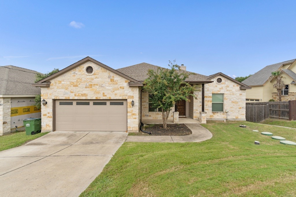 10104 Longhorn Skyway Dripping Springs, TX 78620 - Photo 1 of 1 a front view of a house with a yard and garage