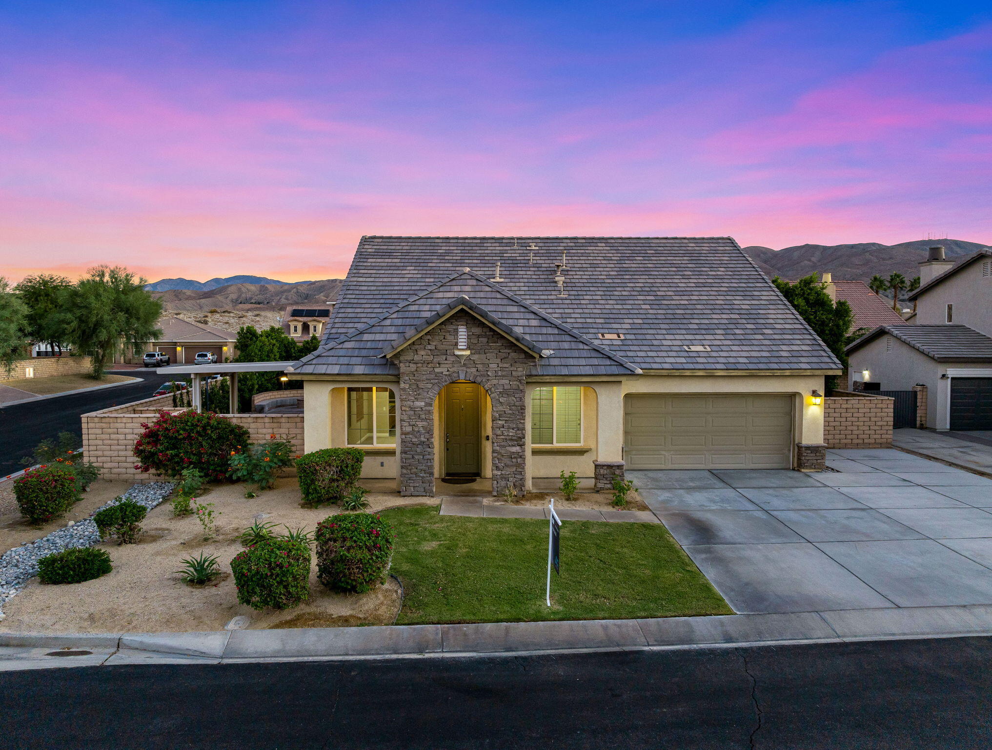 80510 Denton Drive Indio, CA 92203 - Photo 1 of 80 a front view of a house with a yard and potted plants