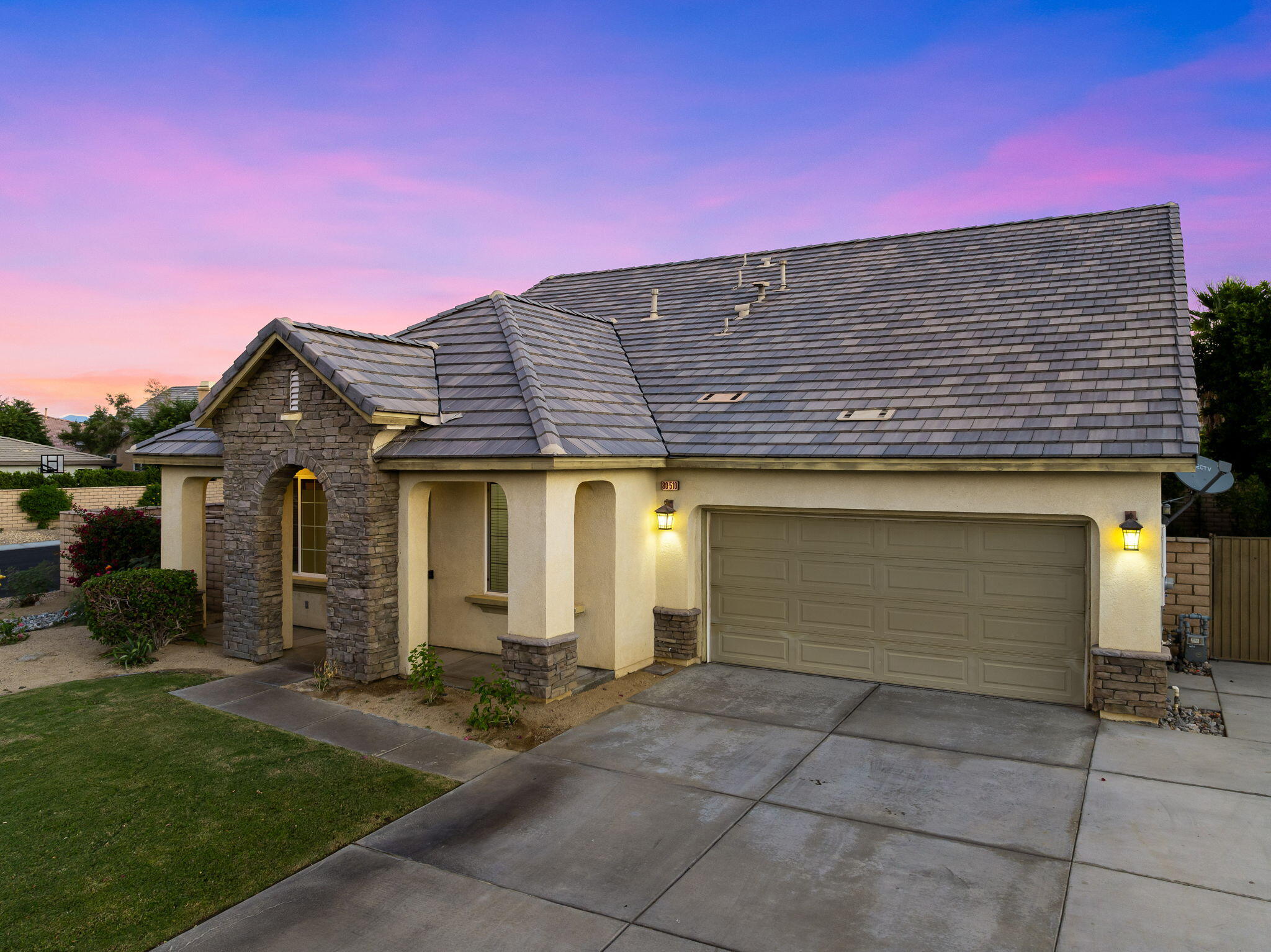80510 Denton Drive Indio, CA 92203 - Photo 15 of 80 a front view of a house with a yard and garage