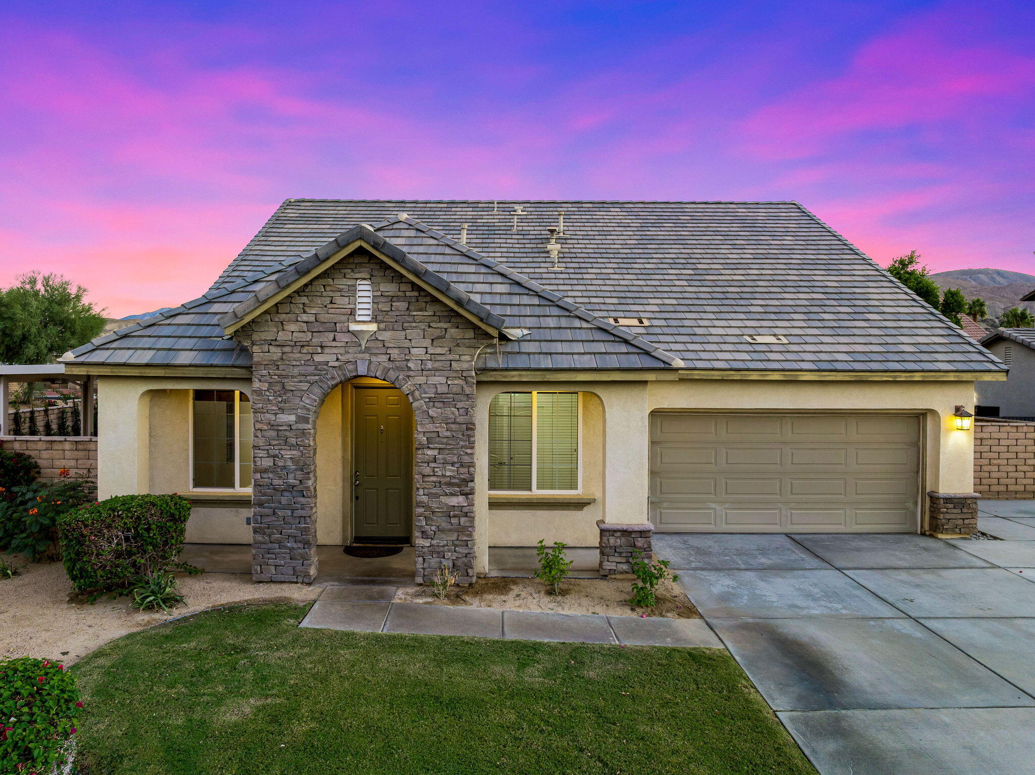 80510 Denton Drive Indio, CA 92203 - Photo 16 of 80 a view of a house with a small yard and a garage