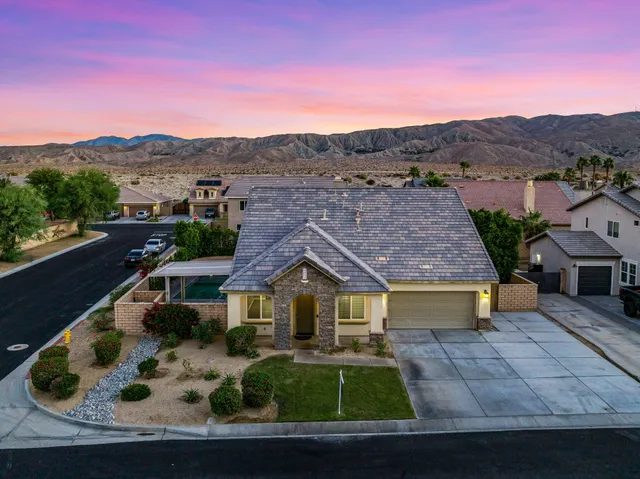 a view of a white house with a yard