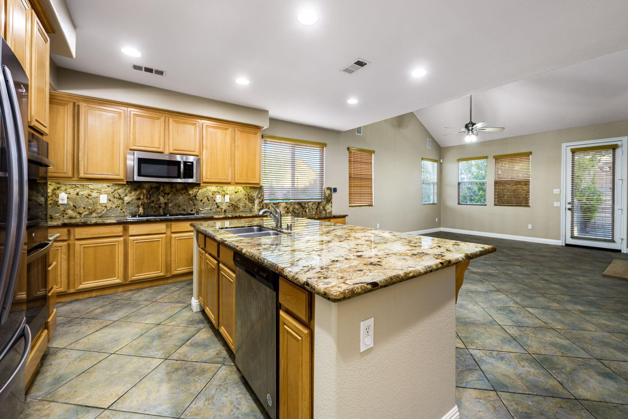80510 Denton Drive Indio, CA 92203 - Photo 22 of 80 a kitchen with granite countertop sink stove and cabinets