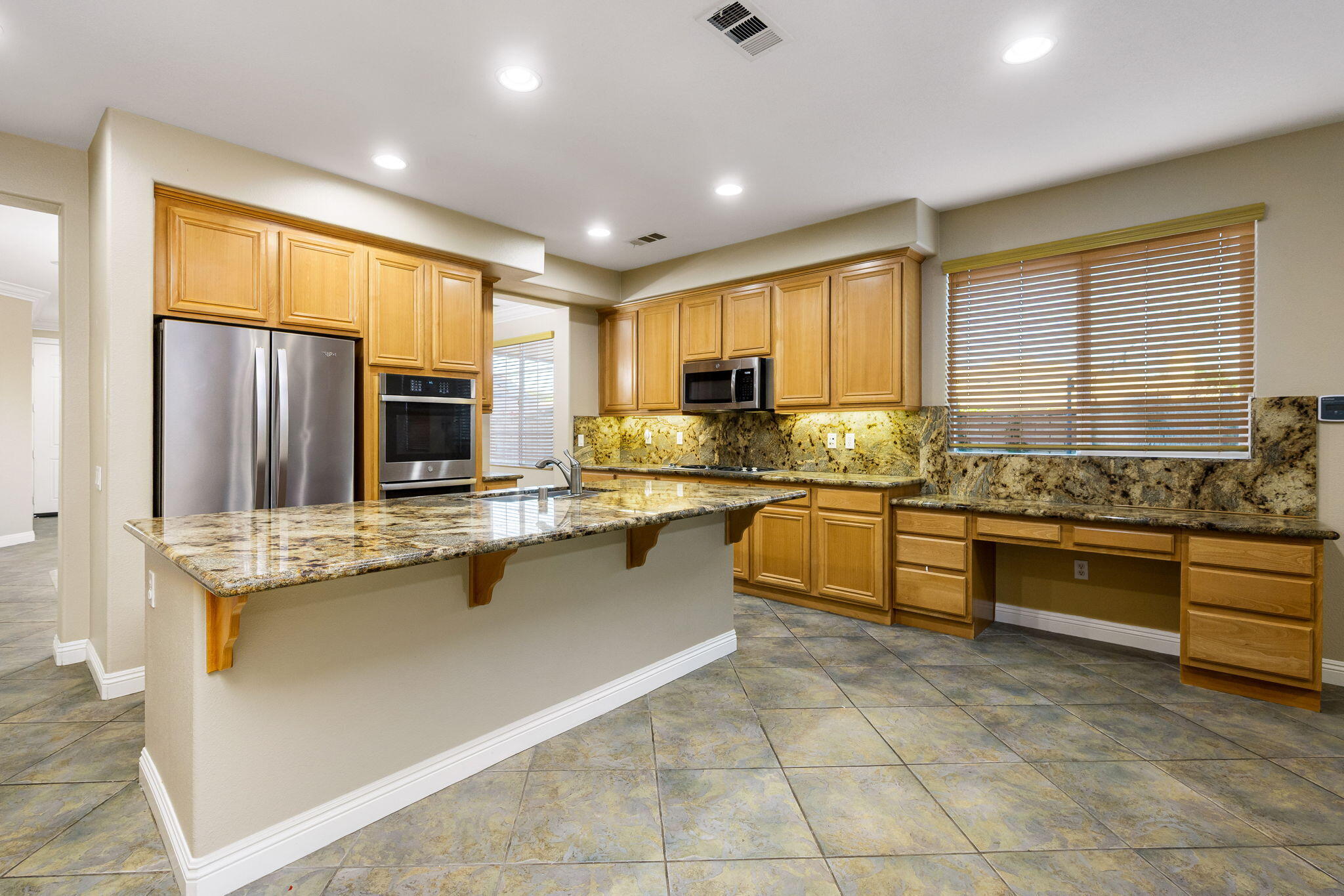 80510 Denton Drive Indio, CA 92203 - Photo 23 of 80 a kitchen with stainless steel appliances granite countertop a stove a sink and a microwave