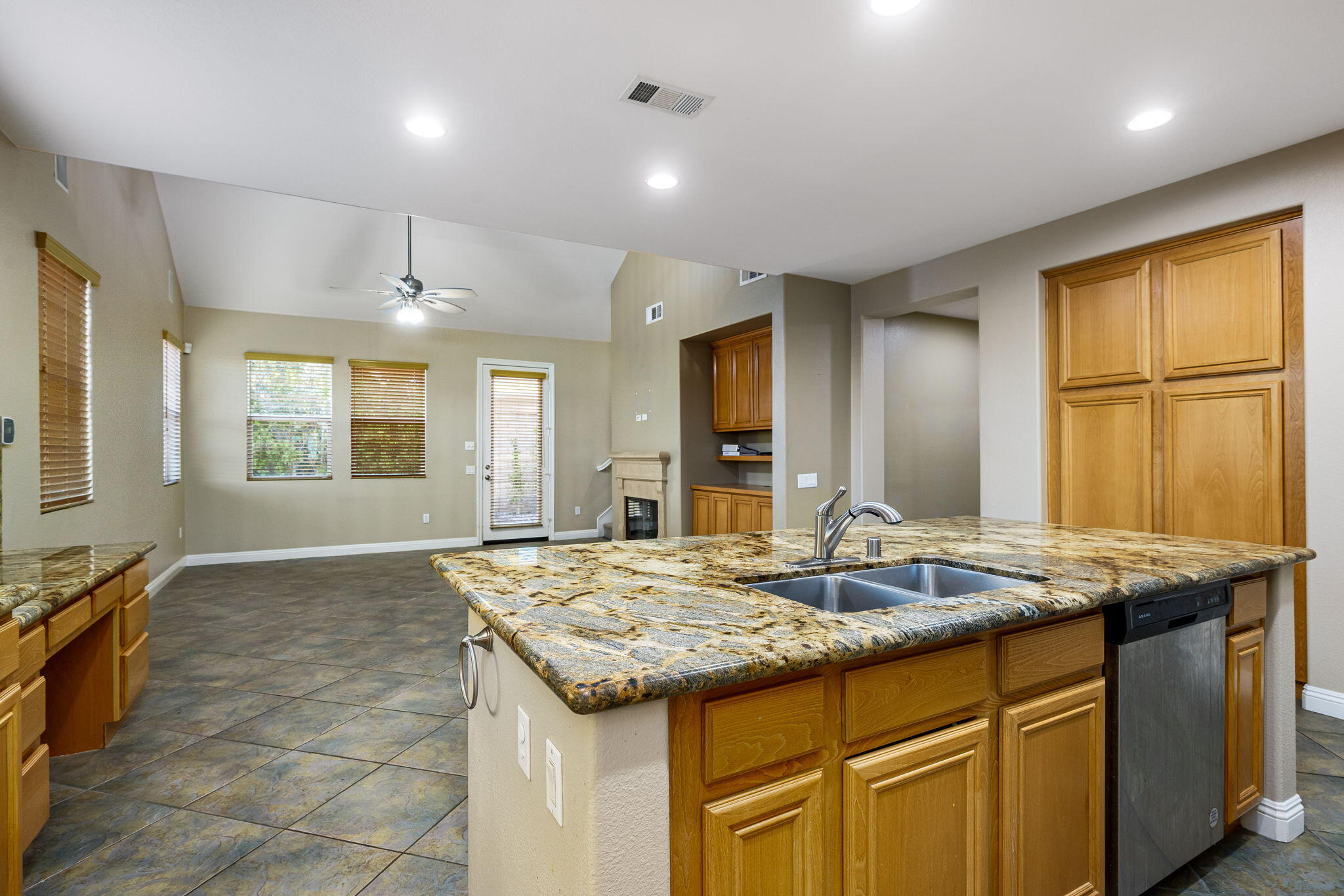 80510 Denton Drive Indio, CA 92203 - Photo 26 of 80 a kitchen with kitchen island granite countertop a stove and a sink
