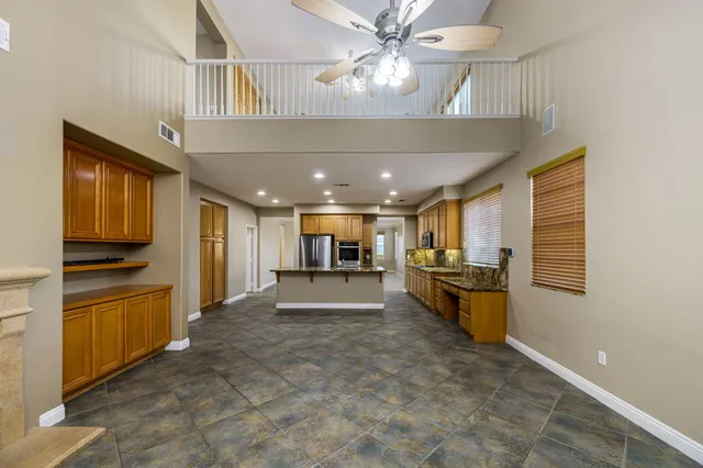a bathroom with a granite countertop sink toilet a mirror and shower