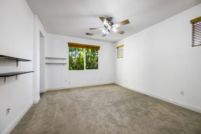 a view of a porch with a table and chairs
