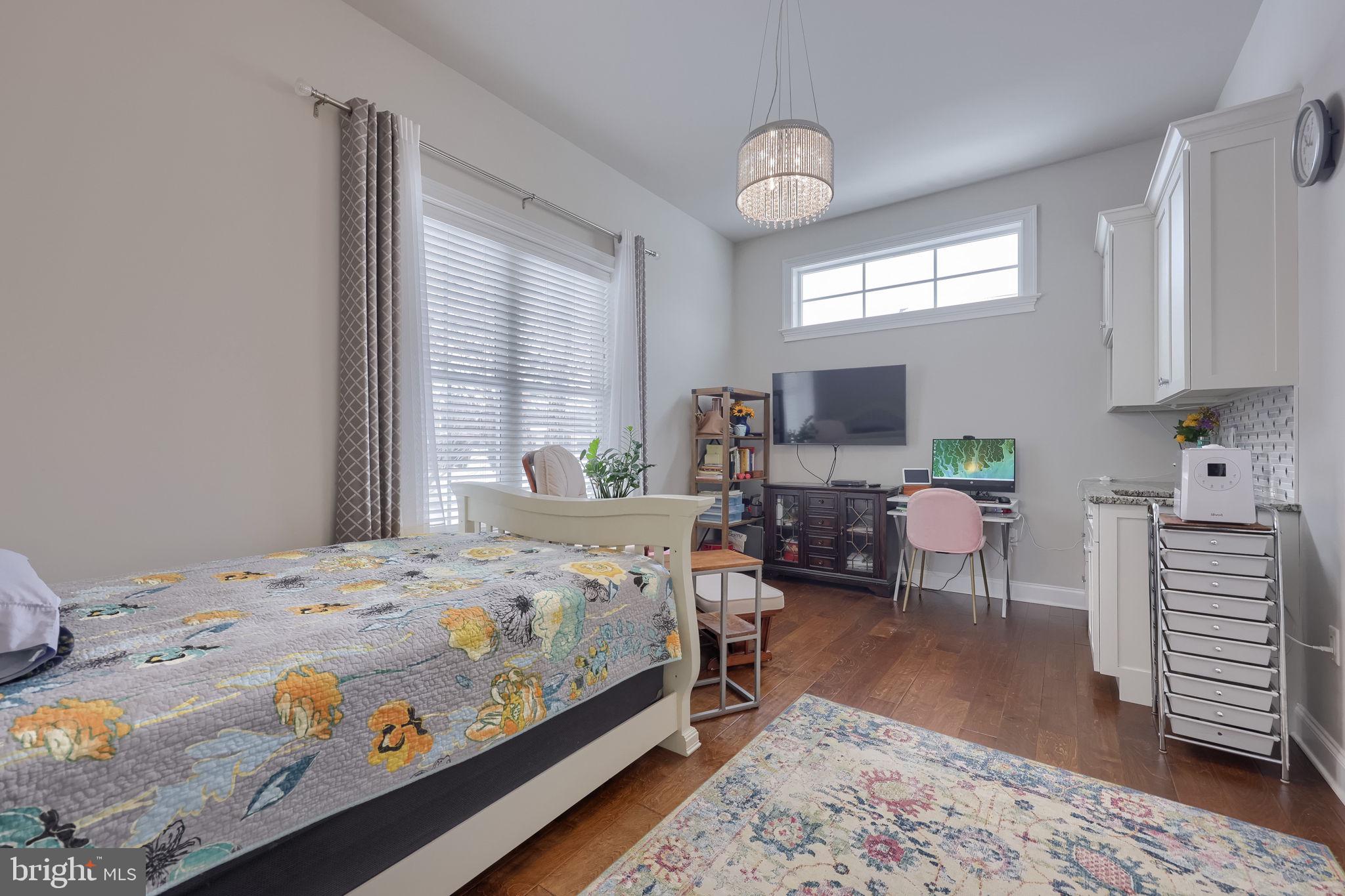 512 East Delp Road Lancaster, PA 17601 - Photo 32 of 75 a bedroom with a bed and wooden floor