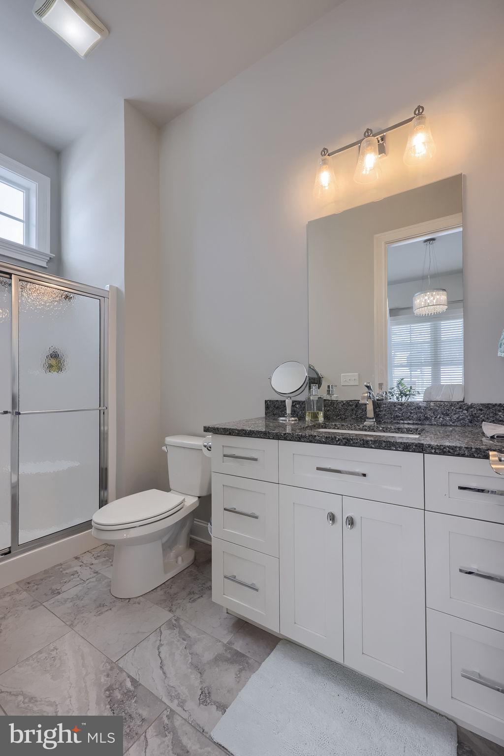 512 East Delp Road Lancaster, PA 17601 - Photo 34 of 75 a bathroom with a toilet a sink and mirror