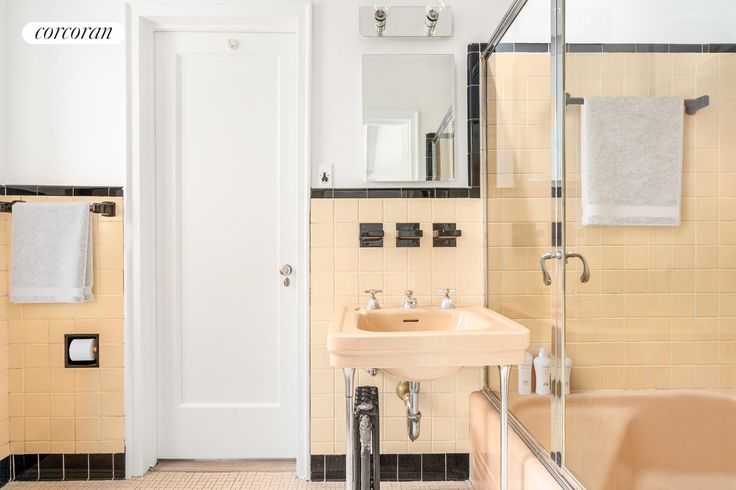 5 Riverside Drive, Unit 5A Manhattan, NY 10023 - Photo 6 of 13 a bathroom with a sink mirror and shower