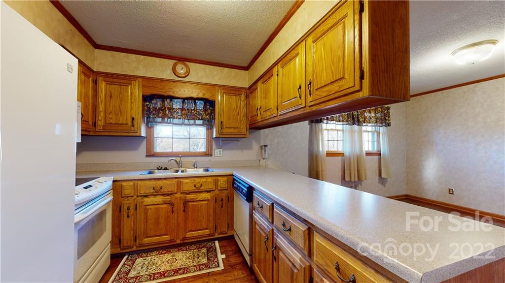 219 Ridge Road Marion, NC 28752 - Photo 13 of 28 a kitchen with stainless steel appliances granite countertop a sink and cabinets