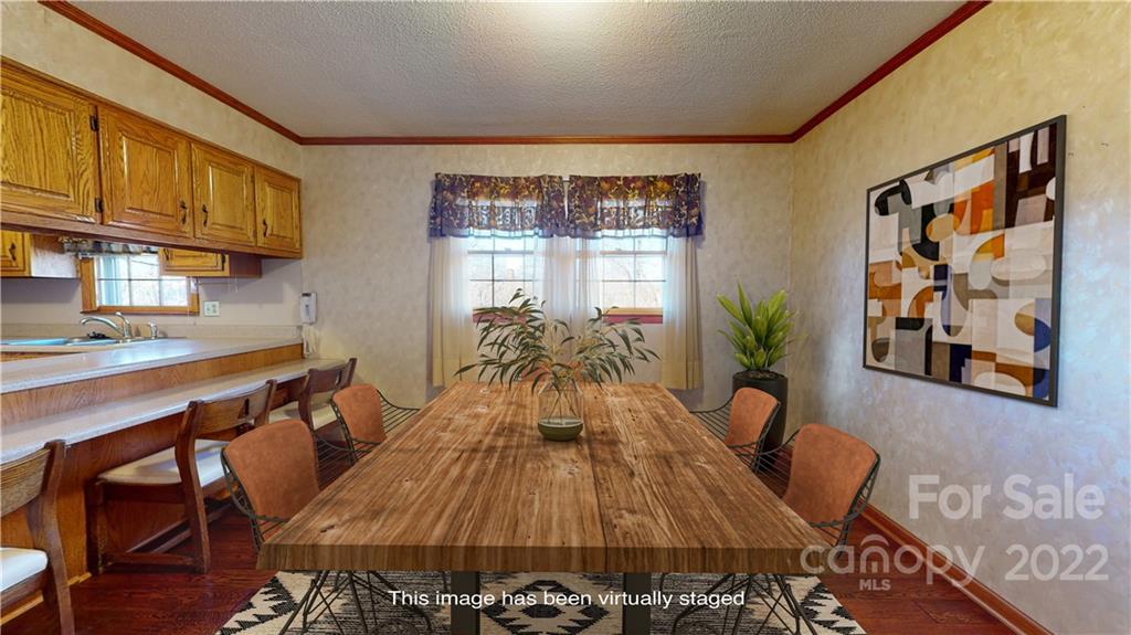 219 Ridge Road Marion, NC 28752 - Photo 14 of 28 a view of a dining room with furniture and wooden floor