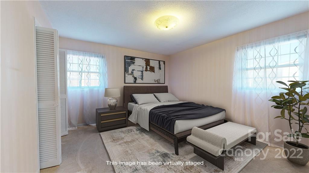 219 Ridge Road Marion, NC 28752 - Photo 19 of 28 a bedroom with furniture and a potted plant