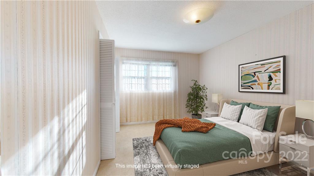 219 Ridge Road Marion, NC 28752 - Photo 21 of 28 a bedroom with a bed and a painting on the wall
