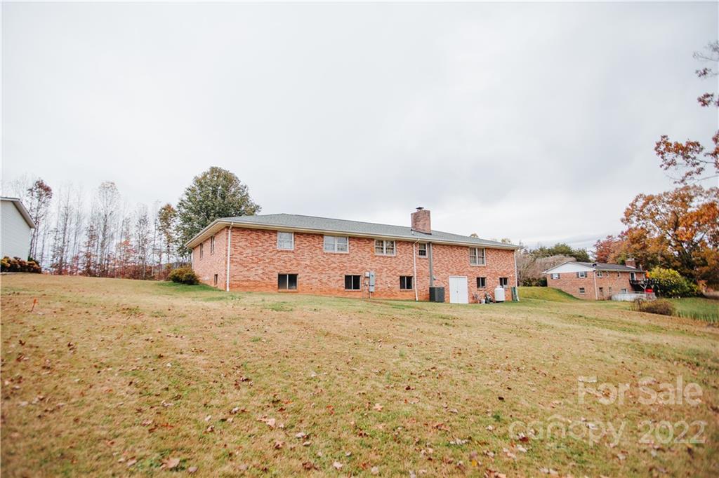 219 Ridge Road Marion, NC 28752 - Photo 4 of 28 a big house with a big yard and large trees