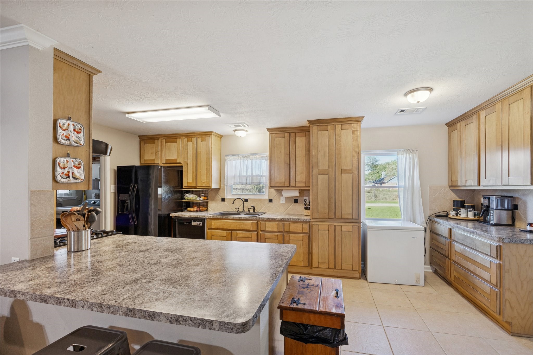 19115 Frey Road Hempstead, TX 77445 - Photo 11 of 35 a kitchen with stainless steel appliances granite countertop a refrigerator and a stove top oven