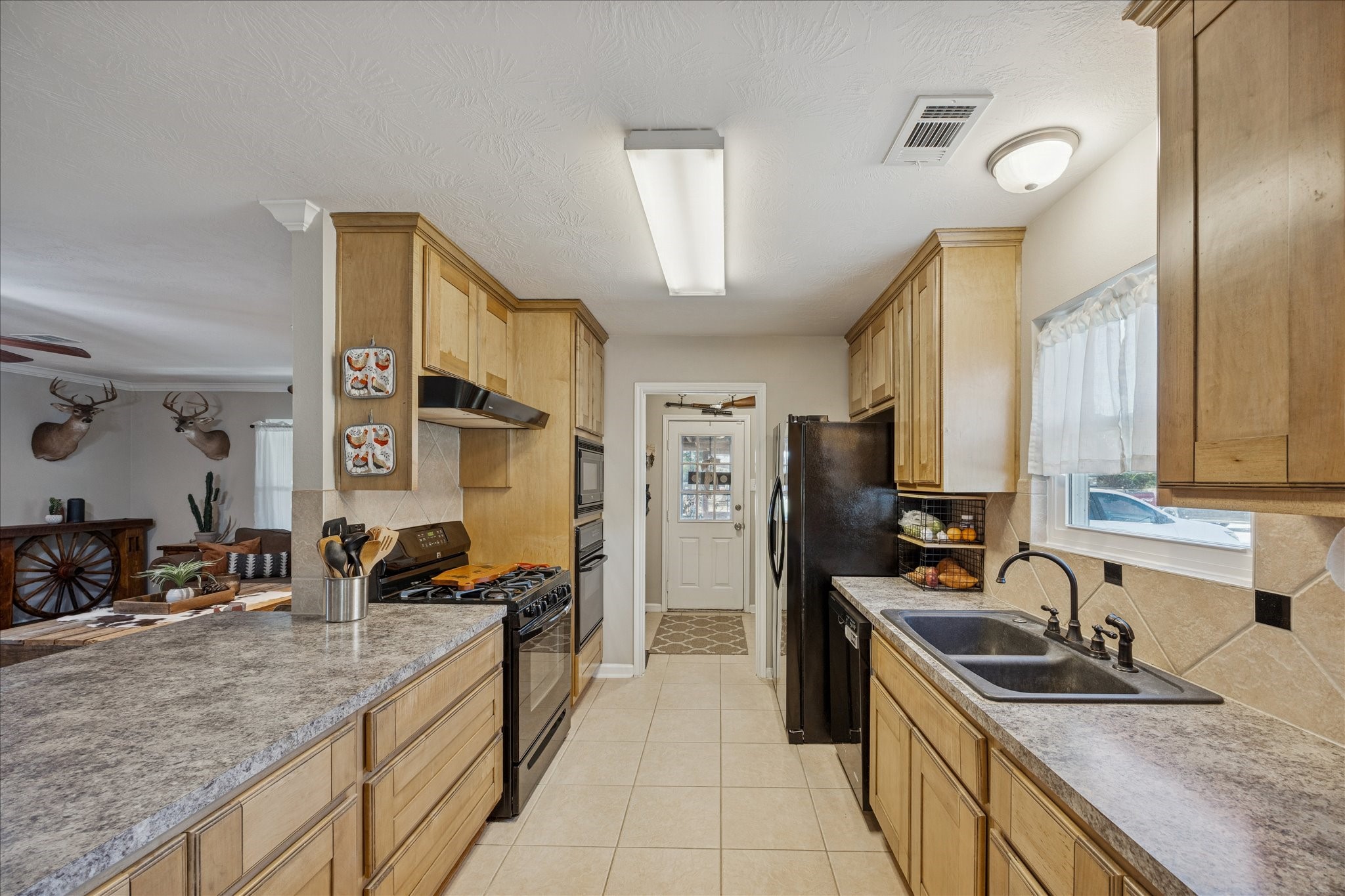 19115 Frey Road Hempstead, TX 77445 - Photo 13 of 35 a kitchen with stainless steel appliances granite countertop a sink a stove and a refrigerator