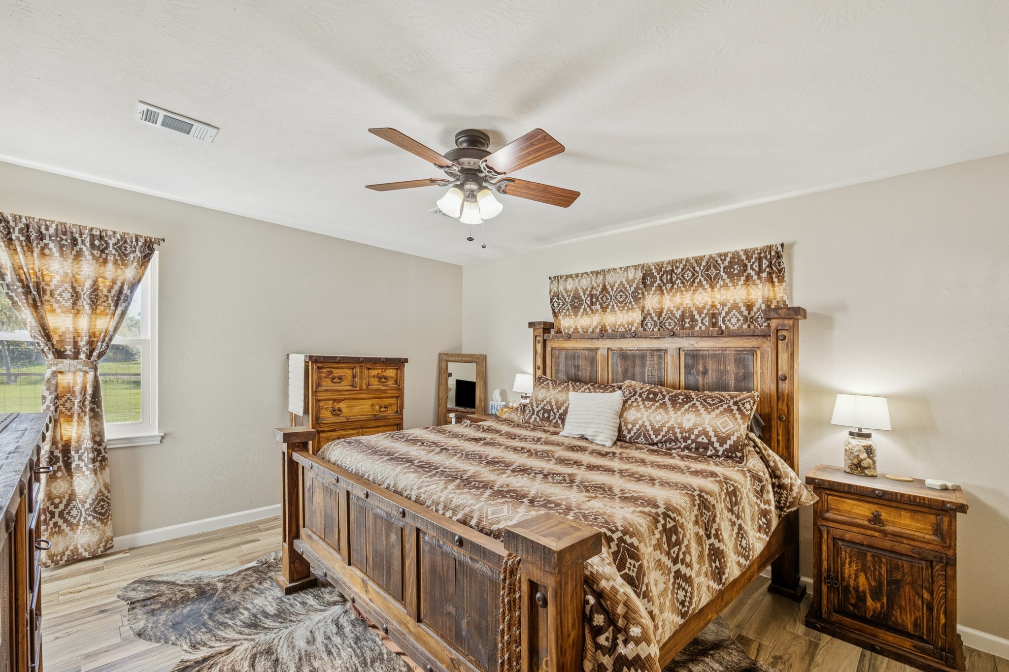 19115 Frey Road Hempstead, TX 77445 - Photo 15 of 35 a bedroom with a bed and a chandelier