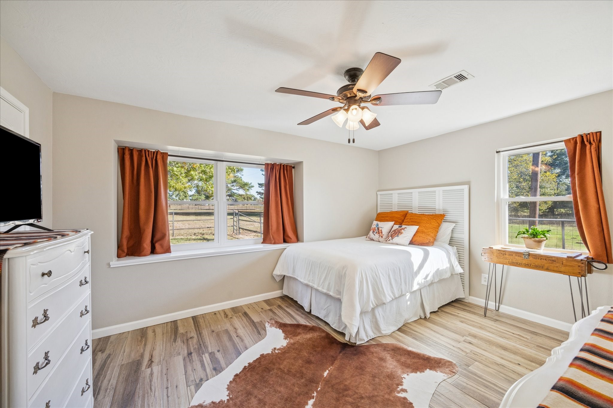 19115 Frey Road Hempstead, TX 77445 - Photo 19 of 35 a bedroom with a bed and a flat tv screen on dresser