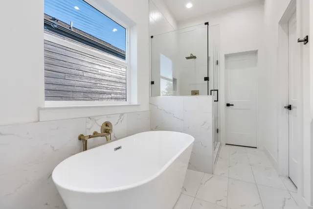 a white bath tub sitting next to a white sink