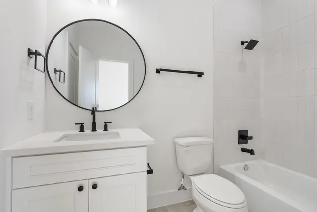 a bathroom with a sink toilet and a mirror