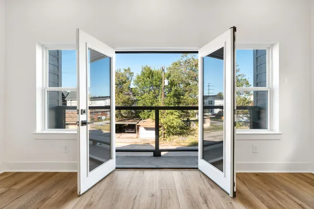 a view of a room with wooden floor and windows