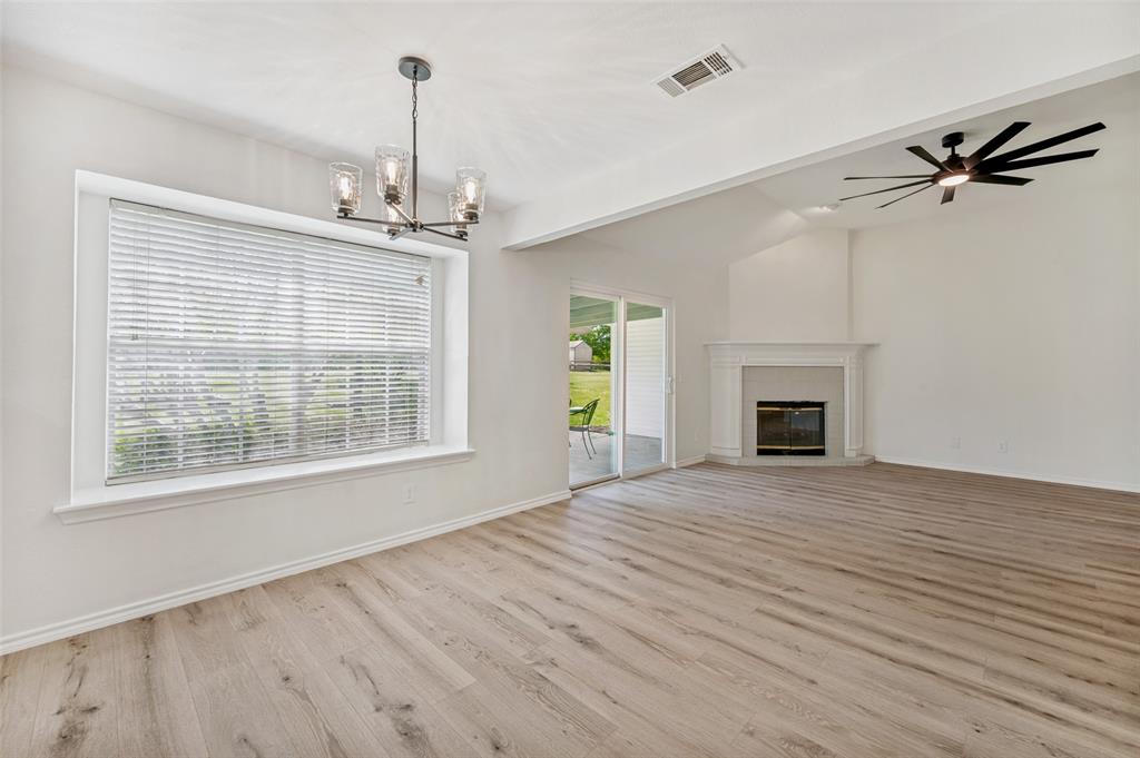 629 Concho Drive Oak Point, TX 75068 - Photo 8 of 35 a view of empty room with wooden floor and fireplace