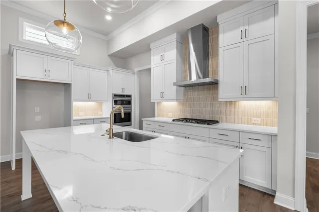 a kitchen with stainless steel appliances granite countertop a sink a stove and a refrigerator