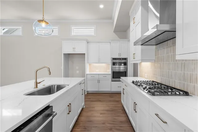 a kitchen with kitchen island stainless steel appliances a sink stove and refrigerator