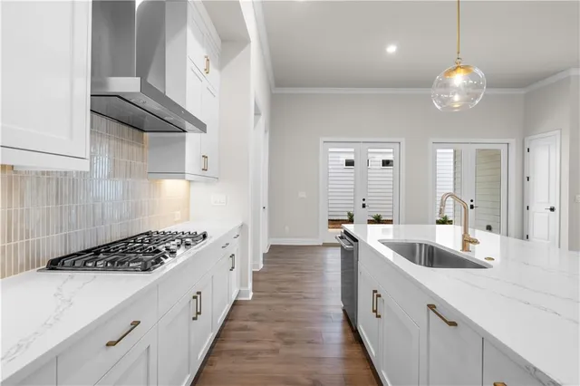 a kitchen with stainless steel appliances a sink stove and cabinets