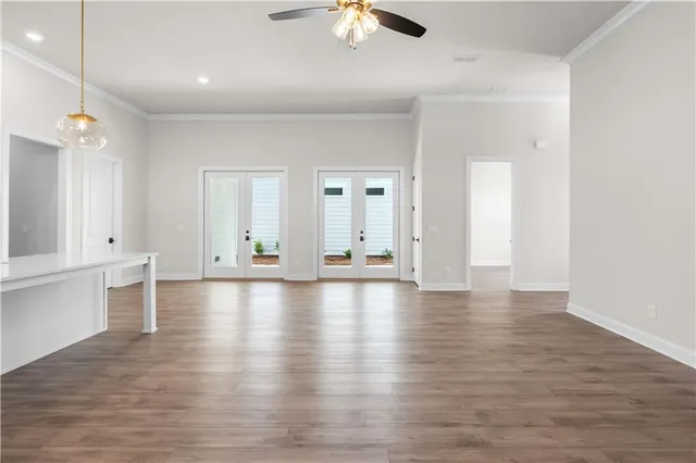 a view of a livingroom with wooden floor and a ceiling fan